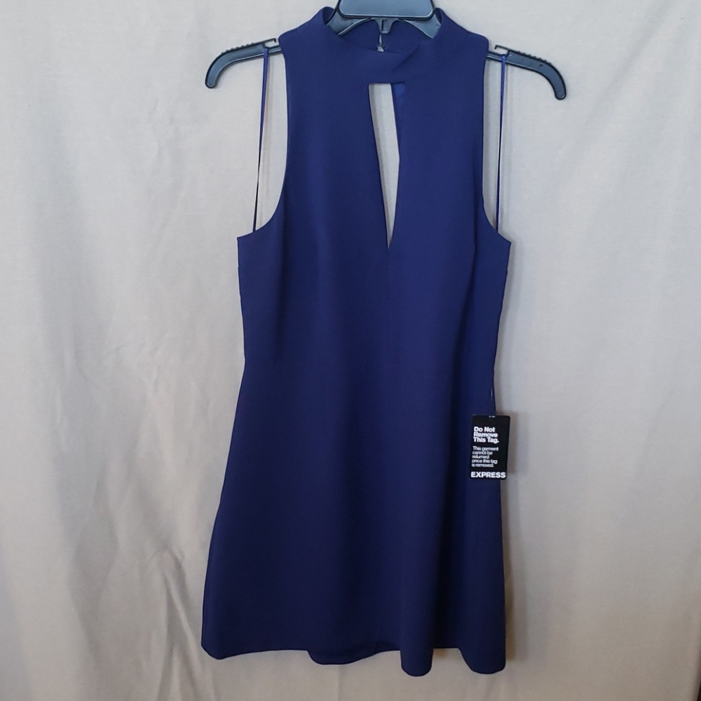 New with Tags! Blue dress with open back.